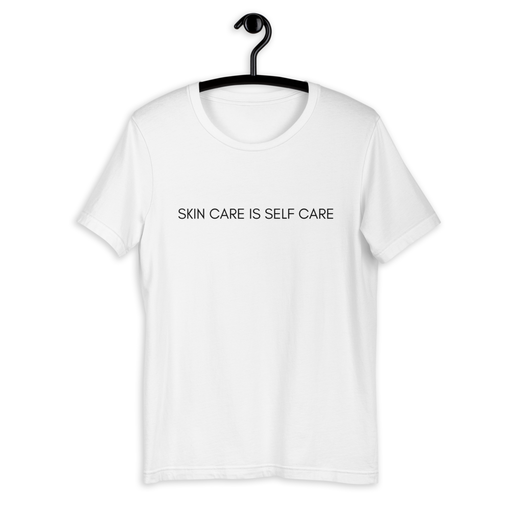 White shirt from Soft Shop with black text centered in front Skin care is self care