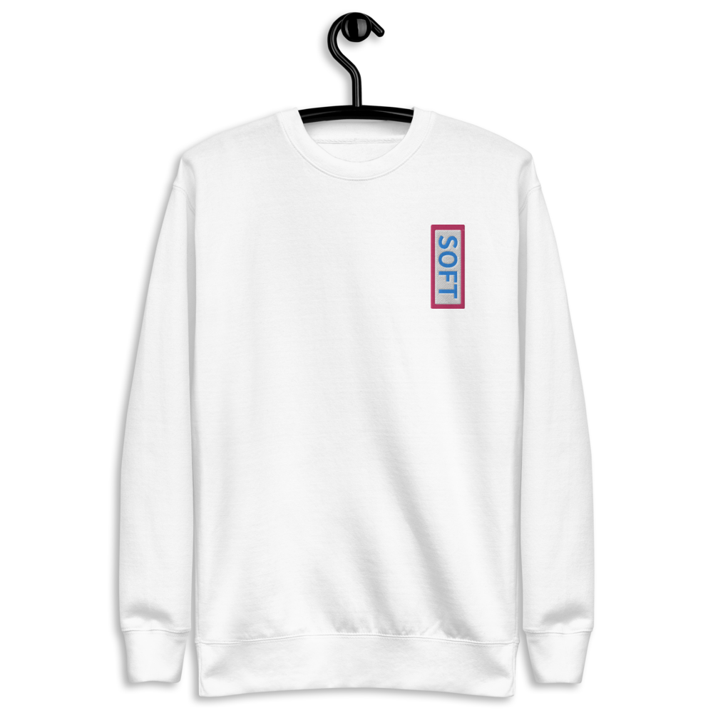 White fleece pullover from Soft Shop with vertical Soft blue lettering in red box
