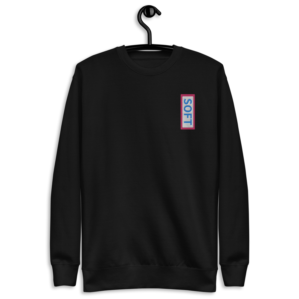 Black fleece pullover from Soft Shop with vertical Soft blue lettering in red box