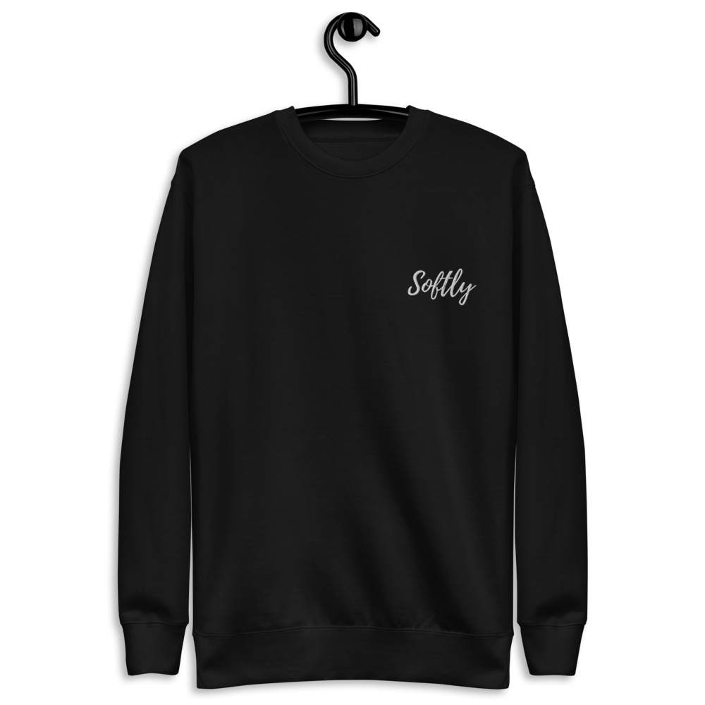Black long sleeve fleece pullover sweater with white embroidered fancy cursive text SOFTLY